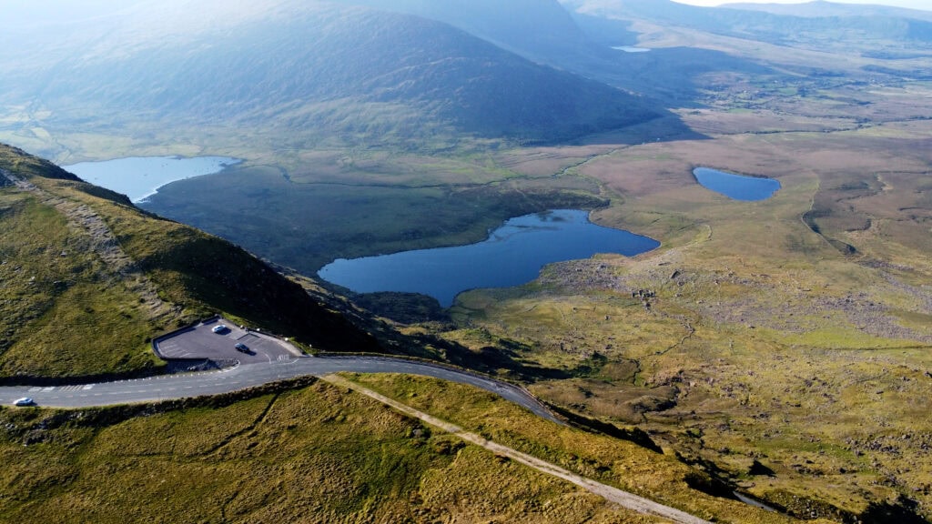 Panoramic view of the Conor Pass Dingle showcasing its winding roads and lush valleys.