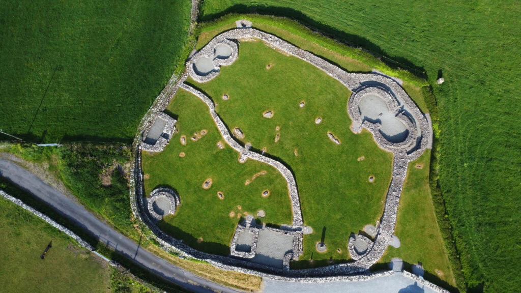 Aerial photo of circular stone structures and carved slabs at Riasc Monastic Settlement on the Dingle Peninsula.