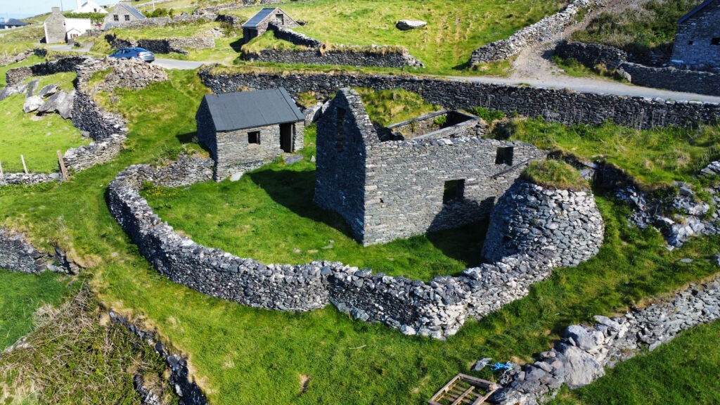 Drone photo of stone ruins from an abandoned village above the Atlantic at Slea Head.