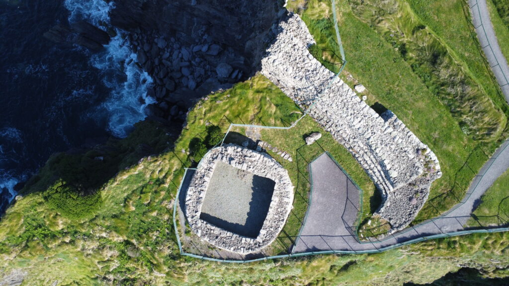 Aerial view of the drystone rampart and enclosed interior of Dún Beag Stone Fort beside steep Atlantic cliffs in County Kerry.