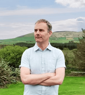 Steven, guide at Steve's Peninsula Tours, standing in the countryside on the Dingle Peninsula, County Kerry.