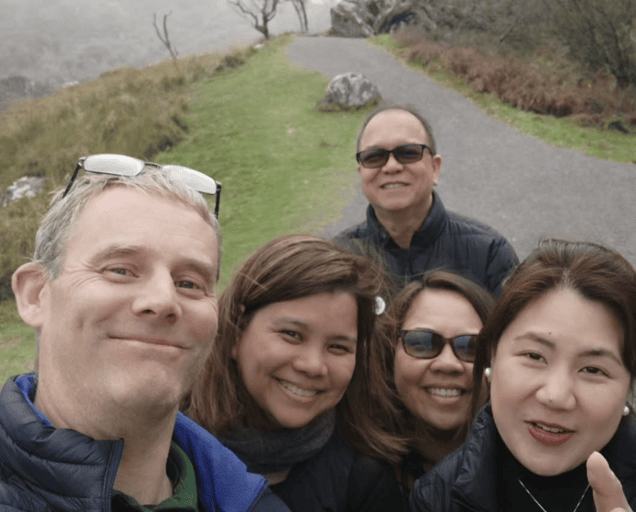 Steven with four tour guests taking a group selfie beside a country road on the Dingle Peninsula, County Kerry.