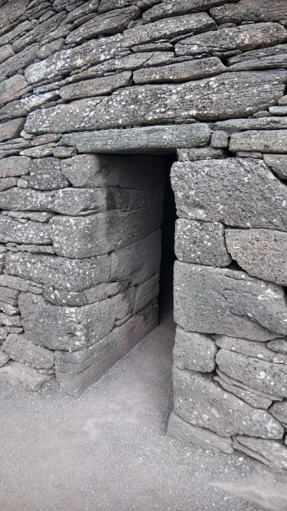Original lintelled doorway of Gallarus Oratory showing the thick dry-stone walls and precisely cut sandstone entrance.