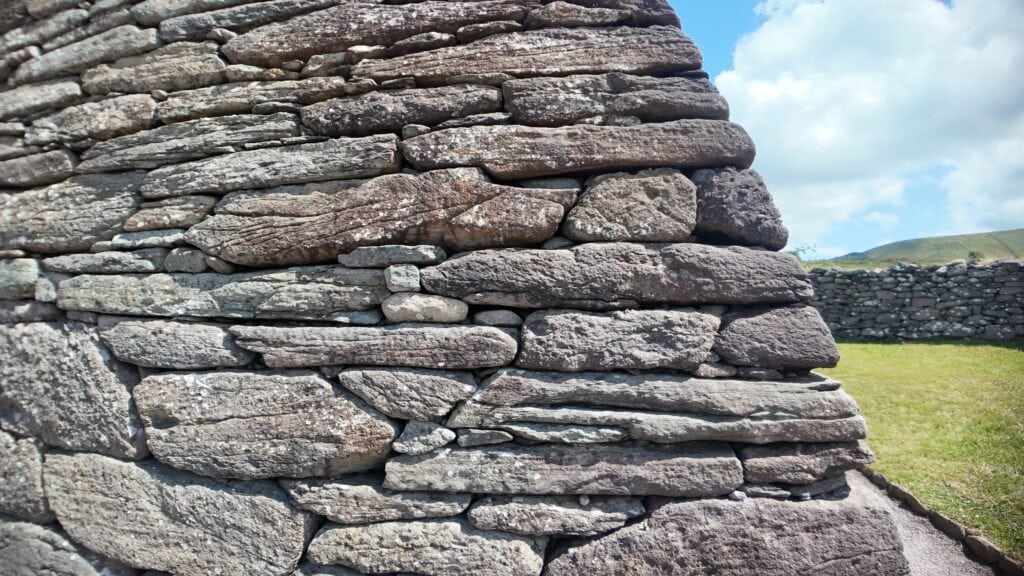 Close-up of the dry-stone masonry at Gallarus Oratory, showing the tightly fitted sandstone blocks used in its corbelled construction.