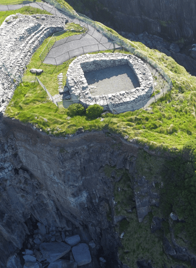 Reconstructed clochán perched above the Atlantic cliffs at Dún Beag Stone Fort on the Dingle Peninsula, County Kerry.