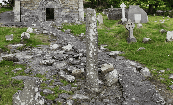 Kilmalkedar ogham stone standing beside the medieval church within the historic graveyard on the Dingle Peninsula, County Kerry.