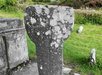 Medieval stone sundial at Kilmalkedar Church standing within the historic graveyard on the Dingle Peninsula, County Kerry.