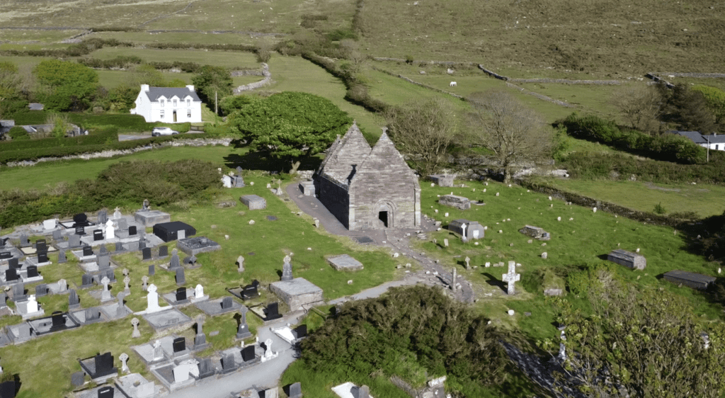 Aerial view of Kilmalkedar Church and its surrounding medieval graveyard on the Dingle Peninsula, County Kerry.