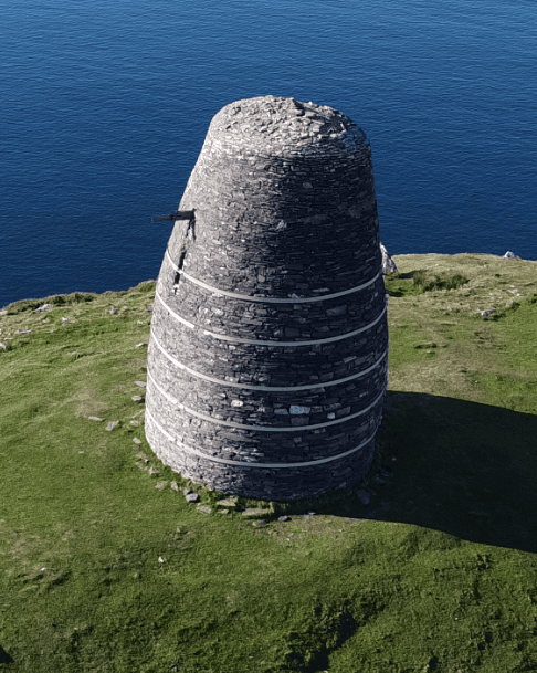 Close aerial view of Eask Tower overlooking the Atlantic Ocean from Carhoo Hill on the Dingle Peninsula, County Kerry.