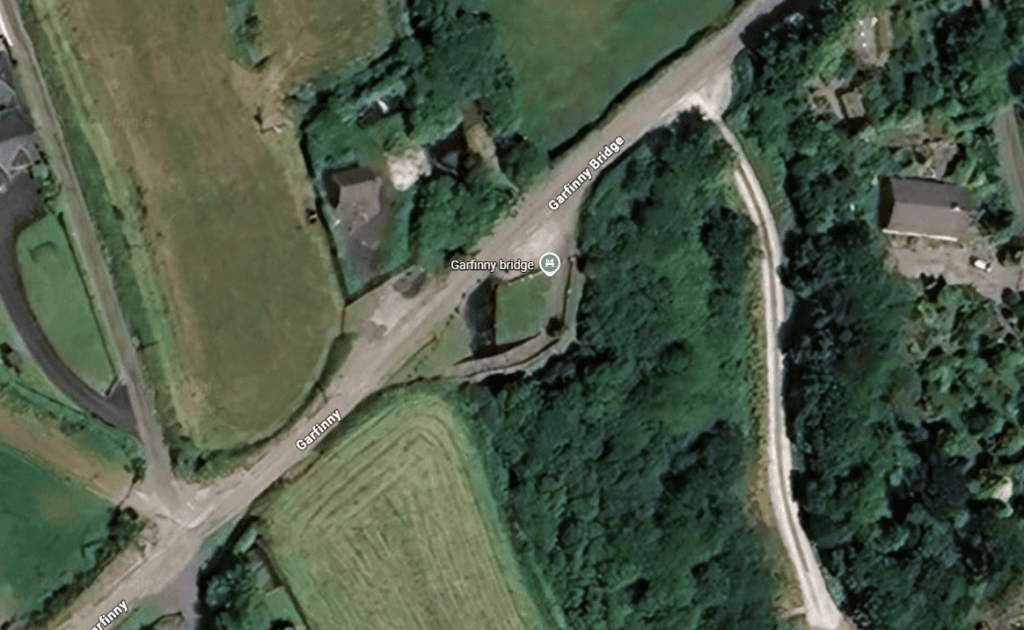 Satellite view showing Garfinny Bridge crossing the Garfinny River near Dingle in County Kerry, surrounded by rural farmland and woodland.