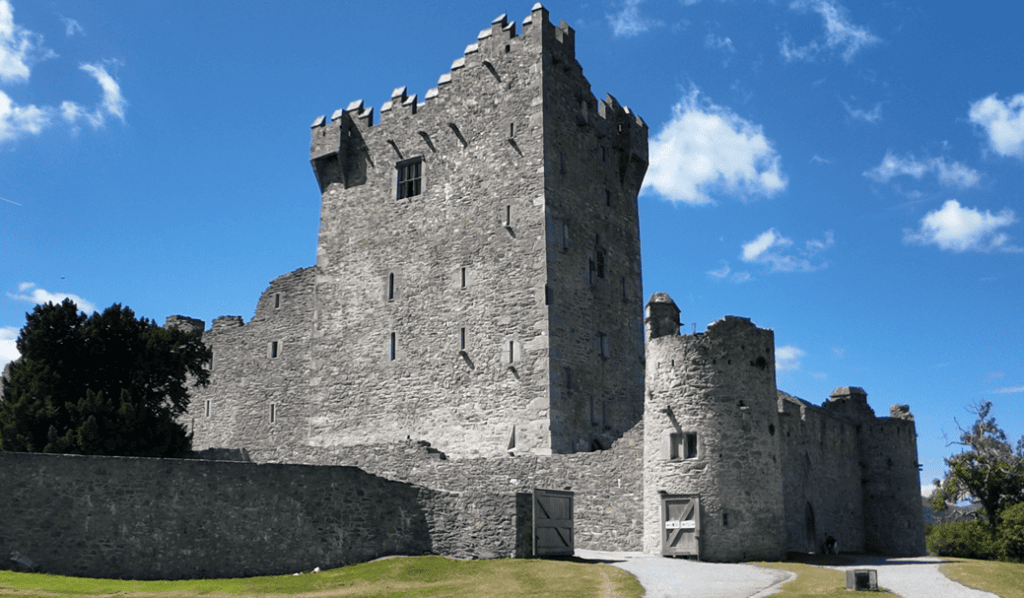 Ross Castle’s fifteenth-century stone tower house and defensive walls beneath a bright blue sky in Killarney National Park.