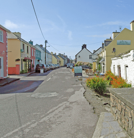 Colourful traditional buildings lining the main street through Portmagee village on the Iveragh Peninsula in County Kerry.