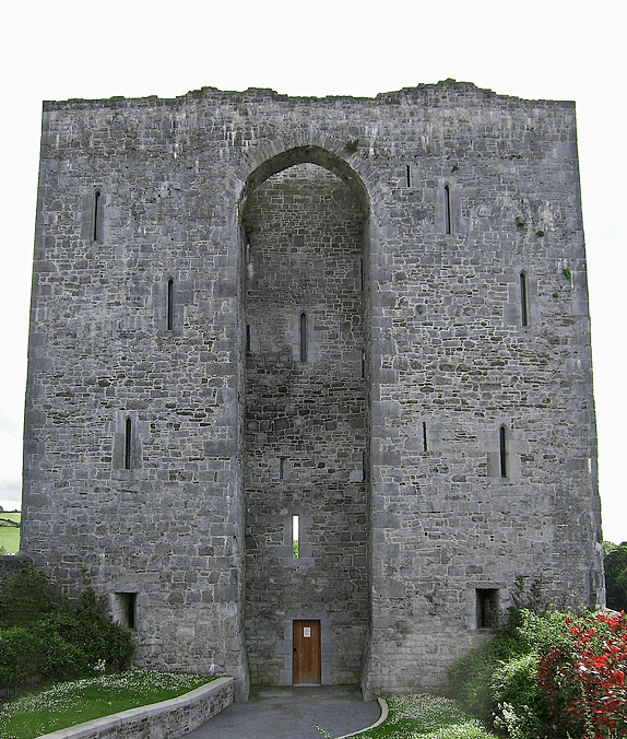 Stone façade of Listowel Castle showing its two surviving towers, central pointed arch and narrow medieval window openings.