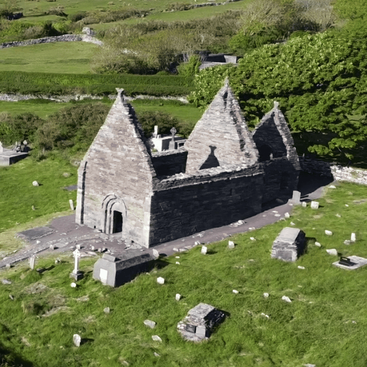 Aerial view of Kilmalkedar Church showing the twelfth-century stone church and surrounding medieval graveyard on the Dingle Peninsula, County Kerry.